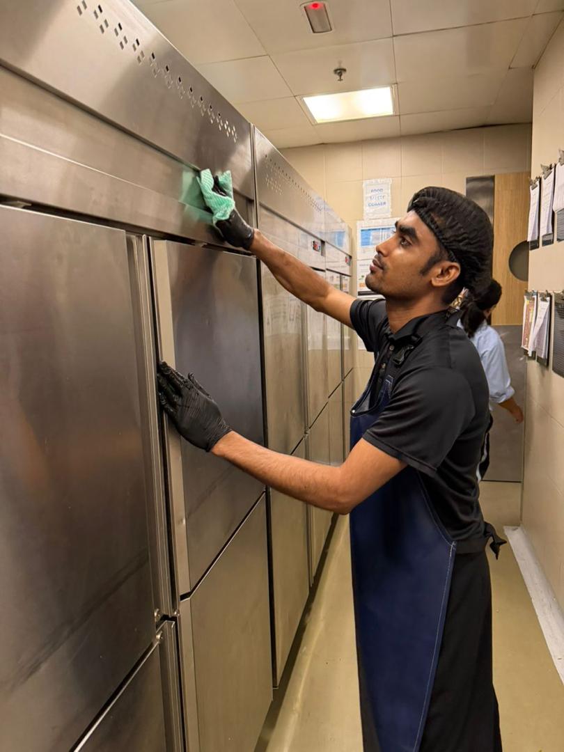 T&M steward maintaining kitchen cleanliness
